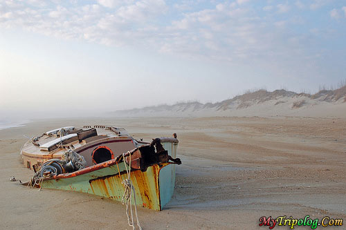 a lonely boat wreckage on the beach,lonely,beach,boat,wreckage,hatteras,island,N.C