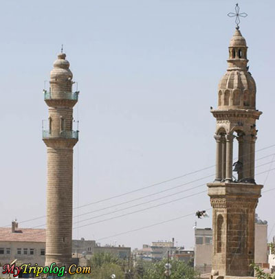 A Mosque minaret and a Bell Tower in the same square,midyat,mardin,bell,tower,minaret,turkey